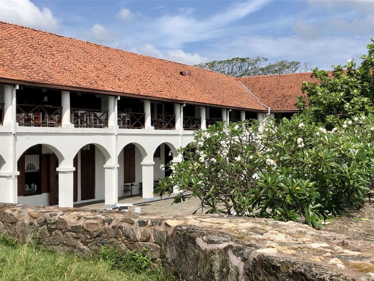 The colonial Dutch Hospital building with its red-tiled roof and arches inside Galle Fort