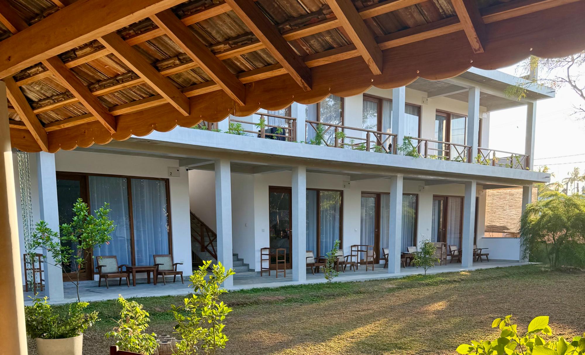 Lily Mirissa's garden pavilion roofline framing the finished hotel building and lawn